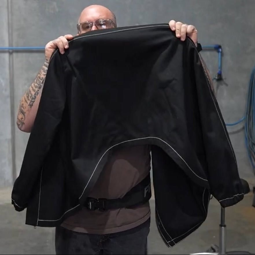 FabPro welding jacket held up to show the lower back cutout above the belt